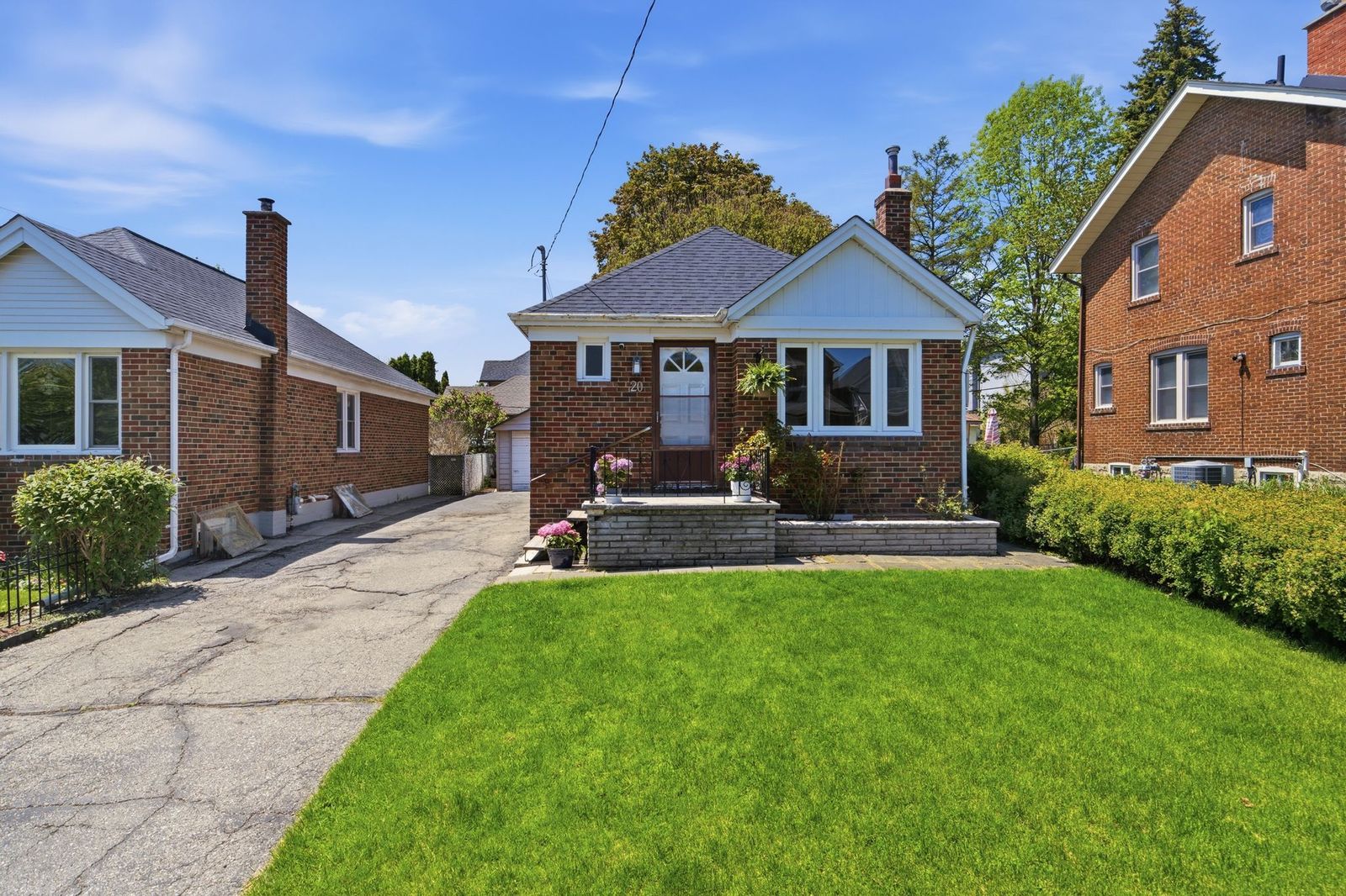 Brick bungalow at 20 Aldgate Avenue with a green front lawn