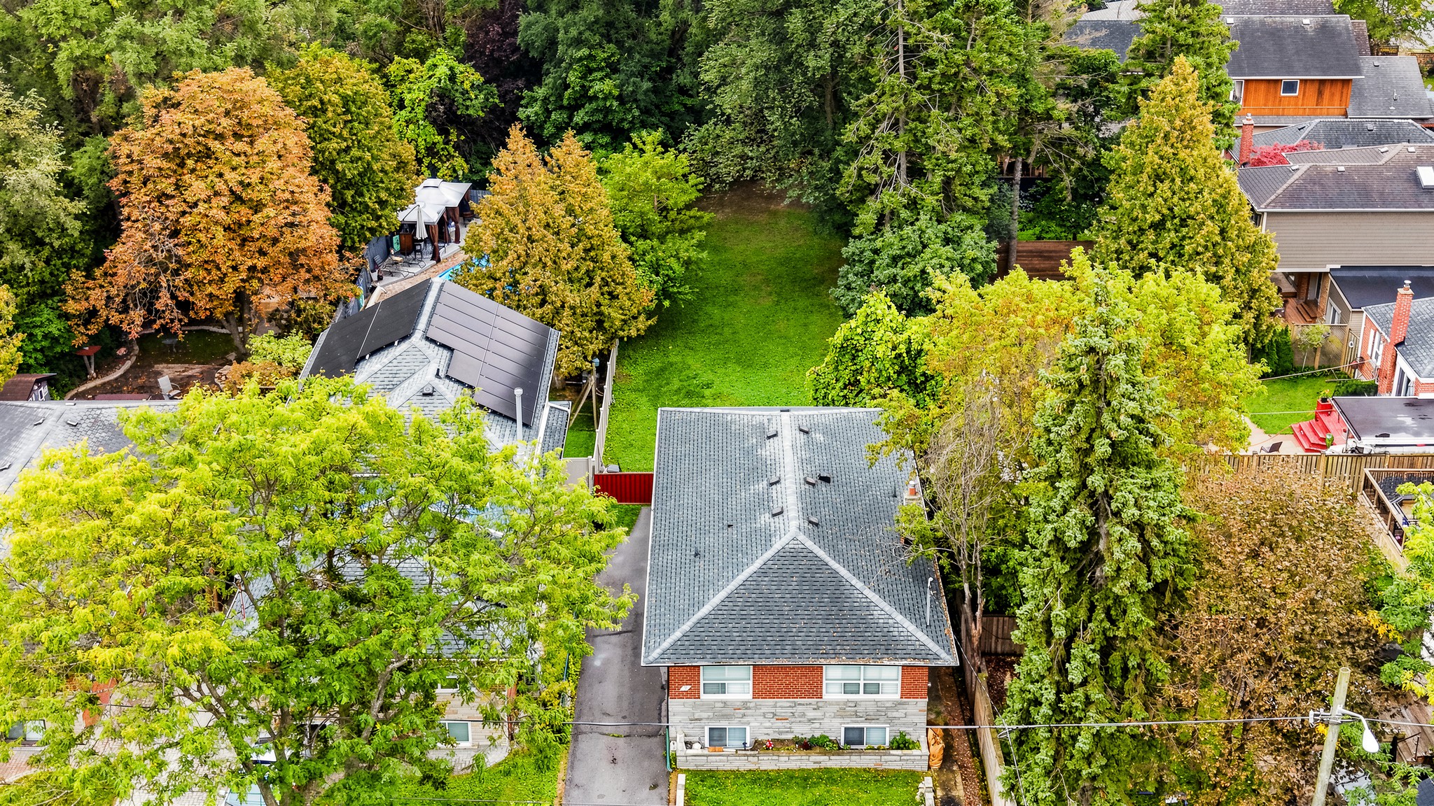 Drone view of 35 Florens Avenue — the house and its deep lot running back to Warden Woods Ravine