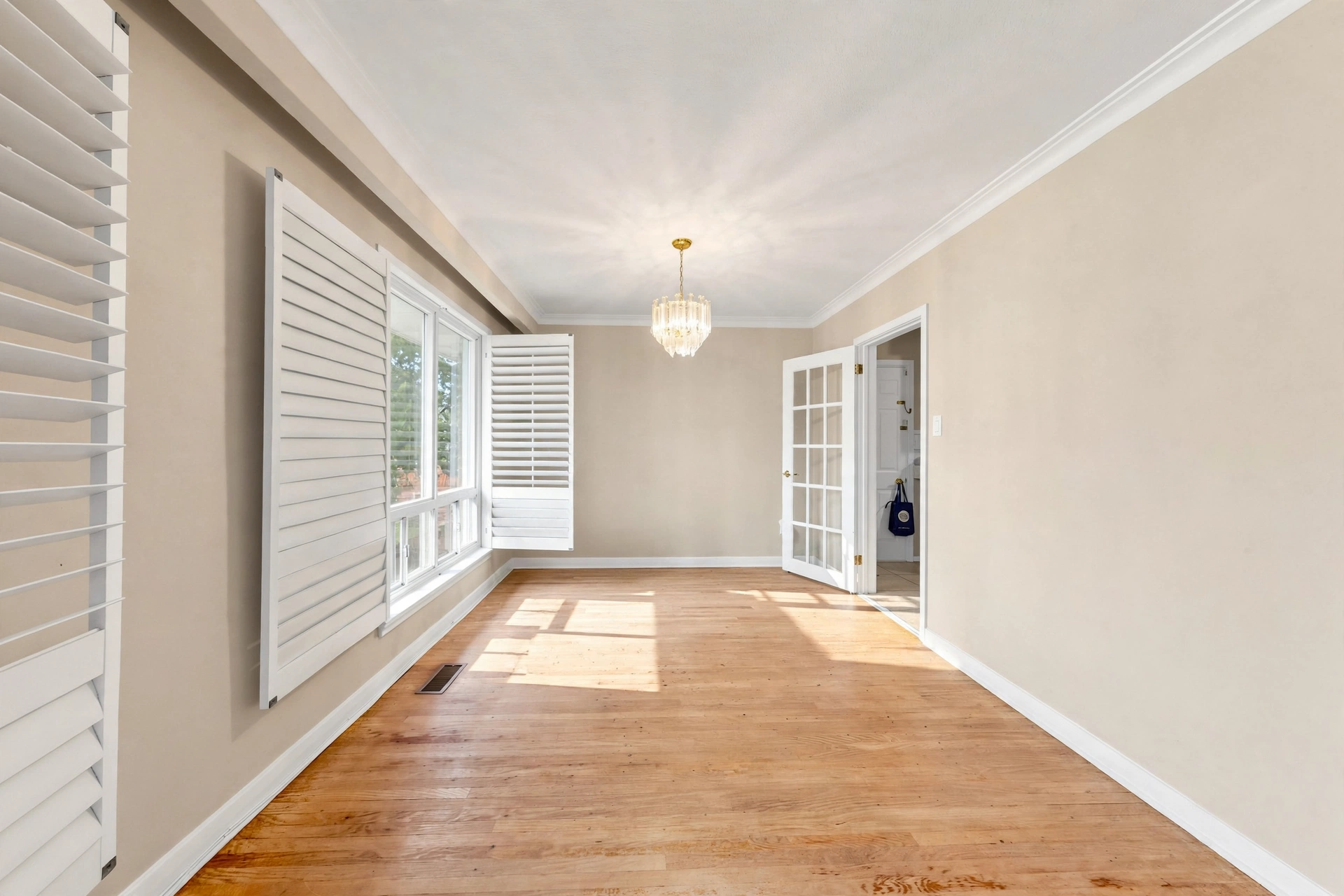 Dining room with hardwood floors and plantation shutters