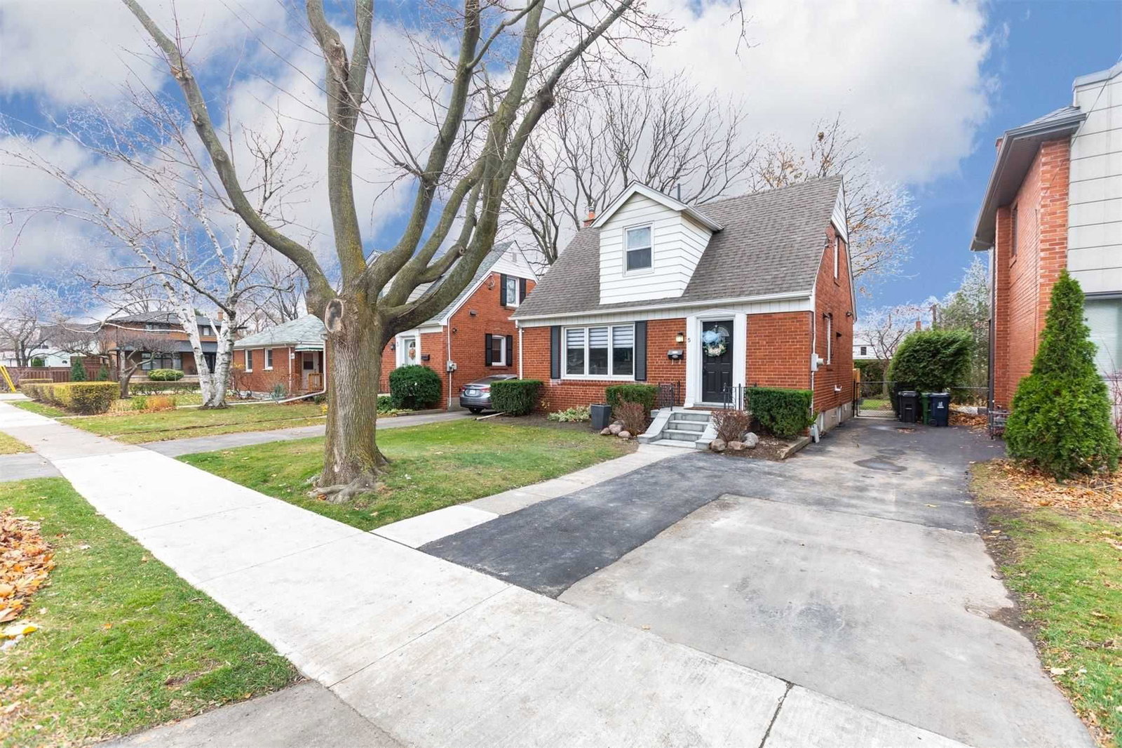 Brick 1.5-storey homes on a tree-lined Alderwood street in Etobicoke
