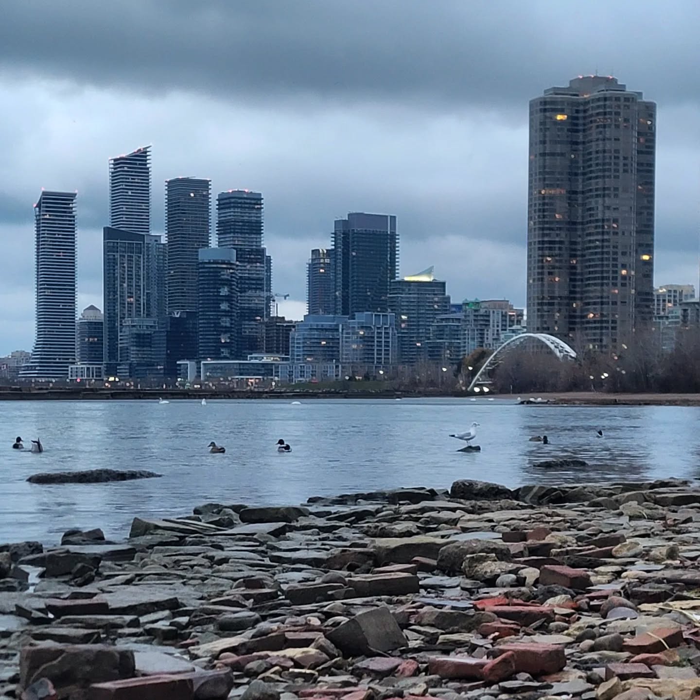 Humber Bay Arch Bridge glowing at sunset with the Toronto skyline behind
