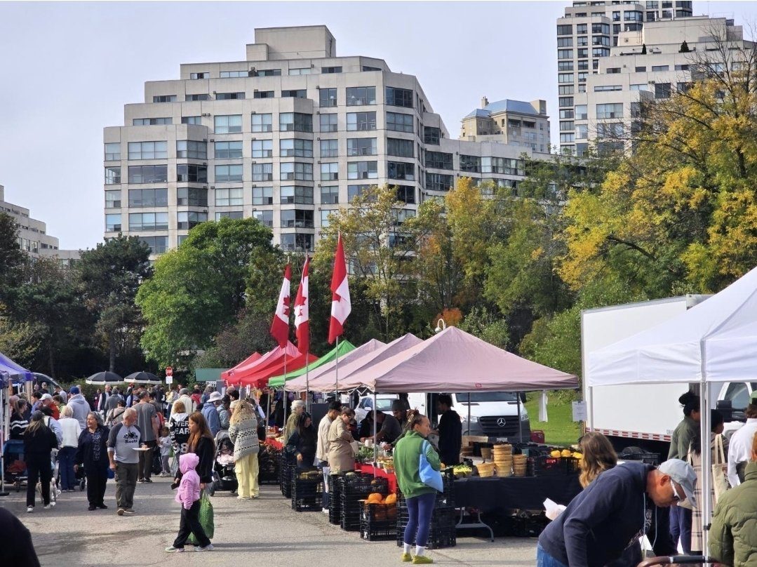 Vendor tents with Canadian flags and Marina Del Rey condos behind, last market day of the 2026 season