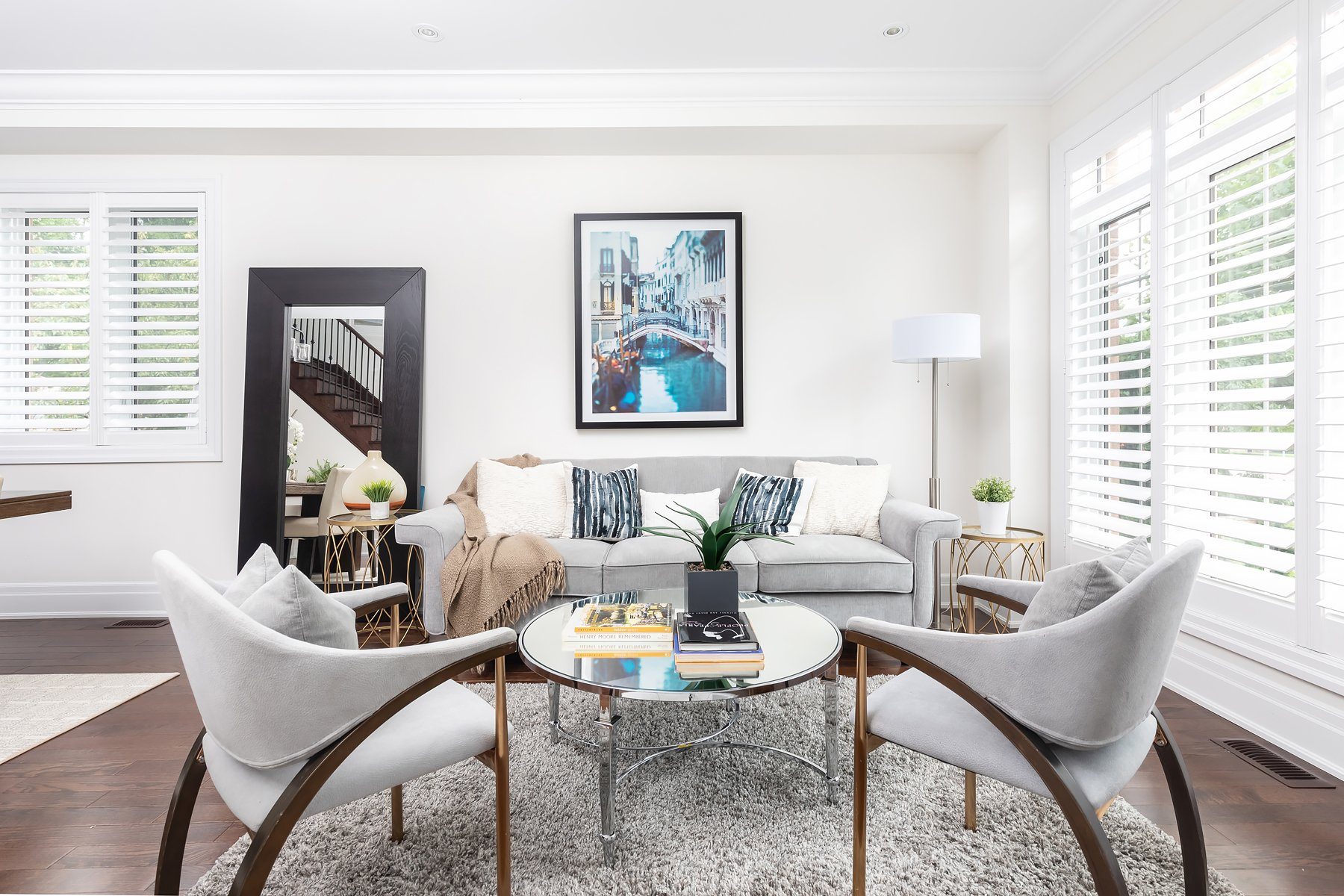 Staged living room with plantation shutters at 106A Hollis Avenue, Toronto, sold by Better Properties