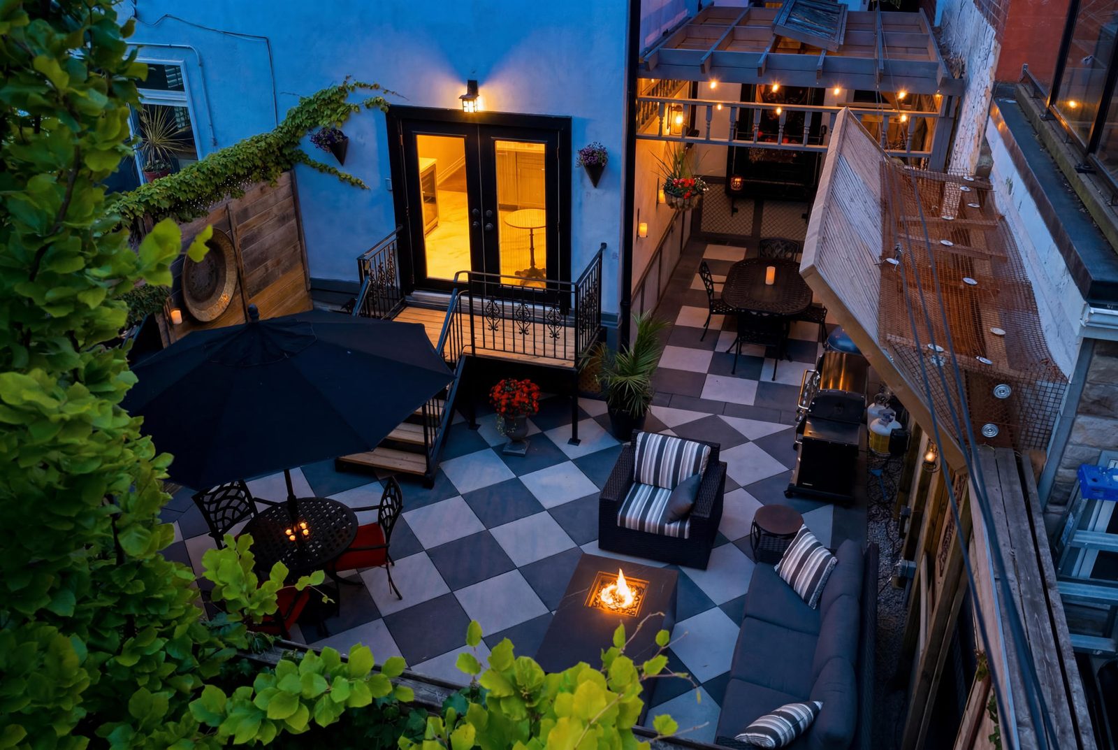 Twilight courtyard with fire pit and checkerboard patio