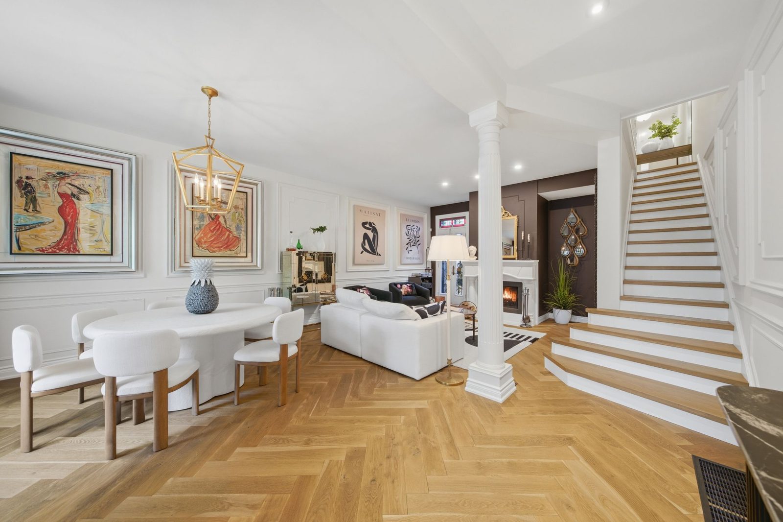 Staged greatroom with herringbone floors and fireplace