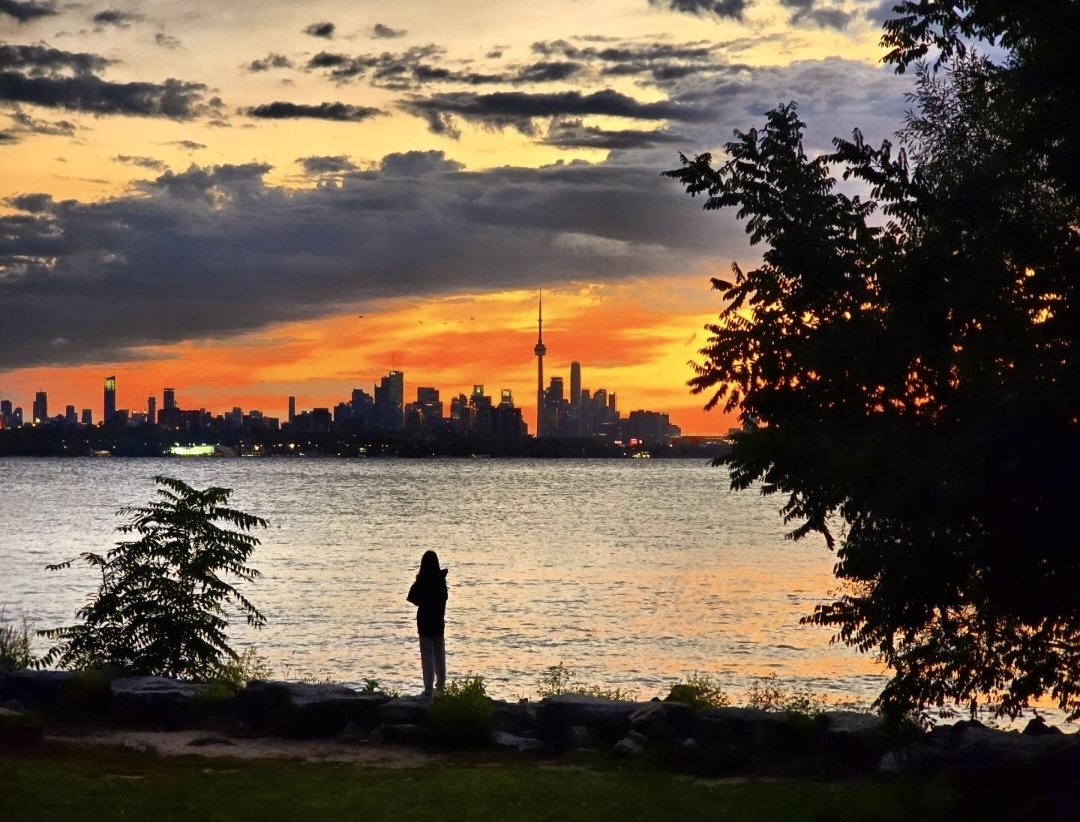 Toronto skyline at sunrise over Lake Ontario, seen from Humber Bay Shores