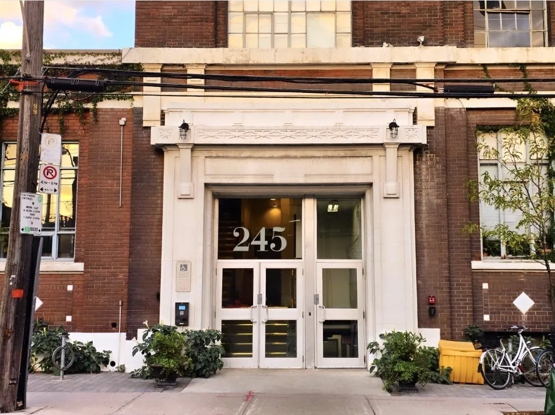 Wrigley Lofts entrance at 245 Carlaw Ave, Toronto: heritage stone doorway with columns at street level
