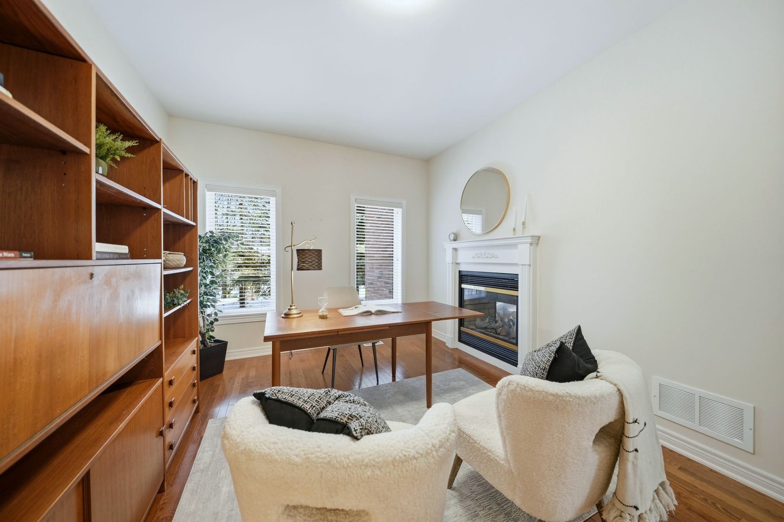 Staged home office with a fireplace and built in bookcase at 192 Williamson Drive East, Ajax