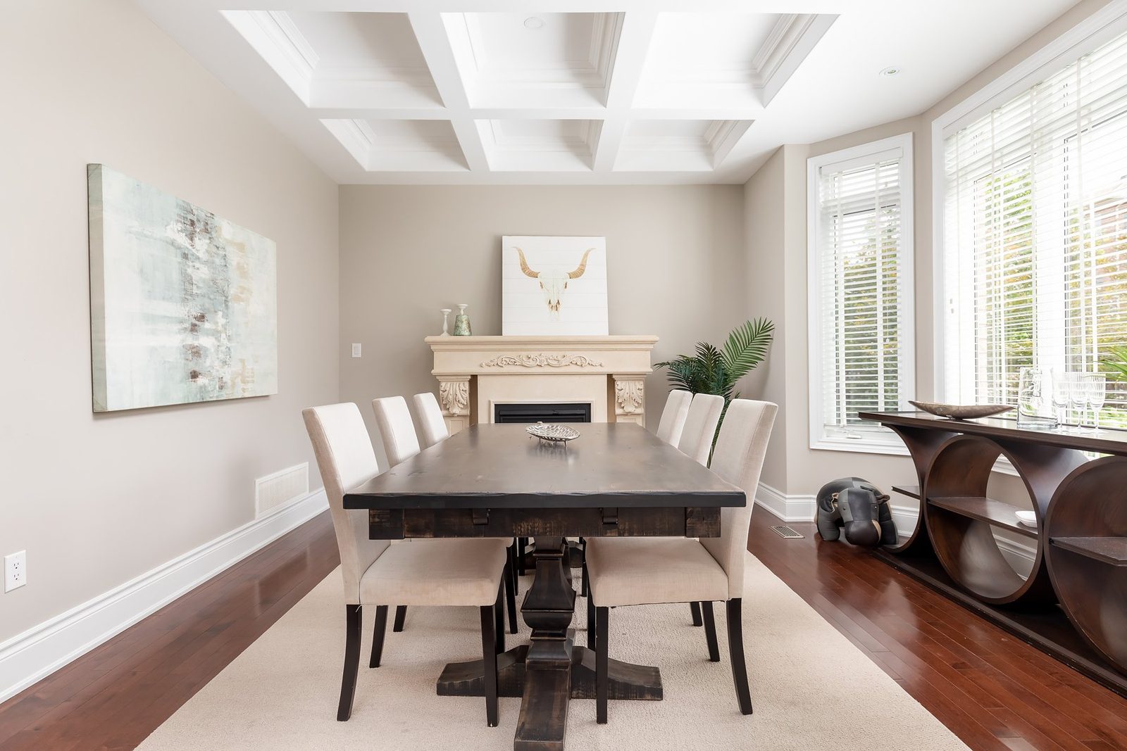 Staged dining room with a coffered ceiling and a long dining table at 33 Noce Way, Vaughan