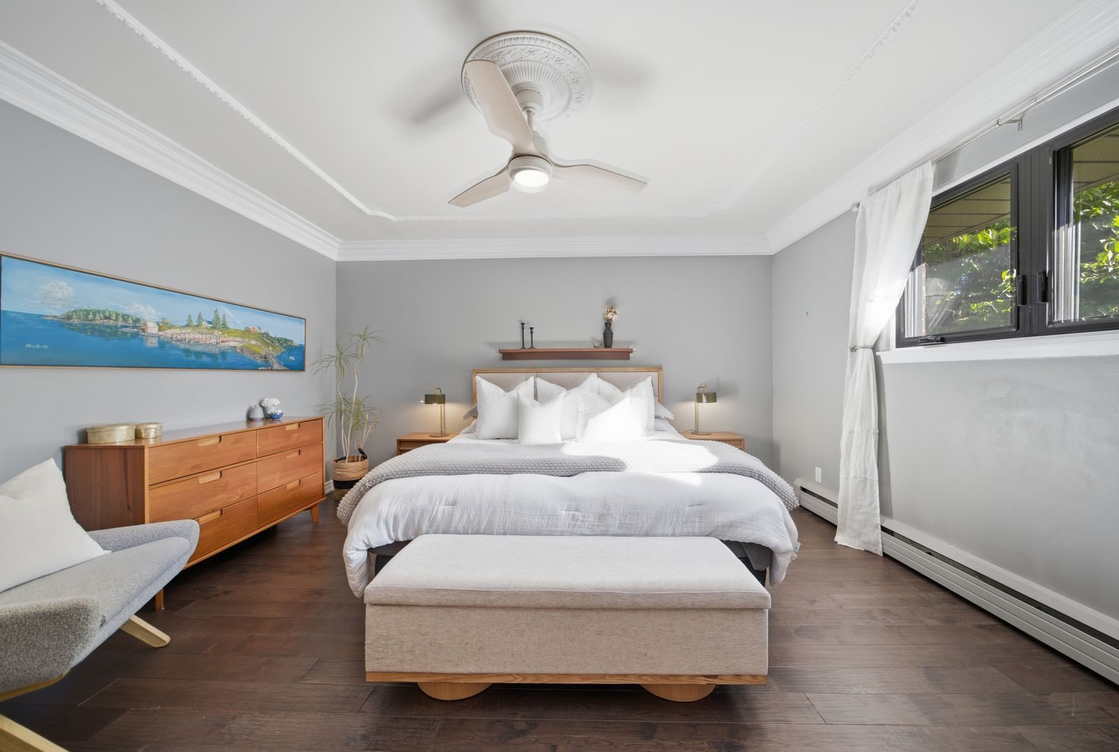Staged bedroom with a ceiling fan and a coastal painting at 52 Morna Avenue, Guildwood, Scarborough