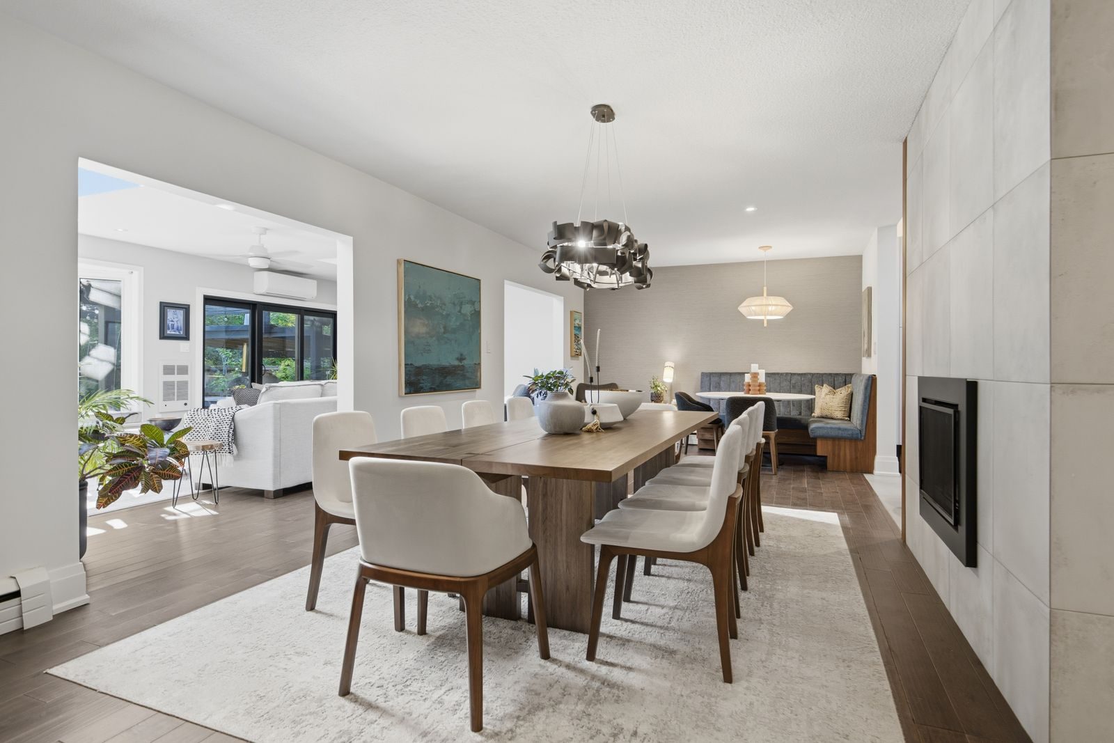 Staged dining room with a fireplace wall and banquette seating opening into the living room at 52 Morna Avenue, Guildwood, Scarborough