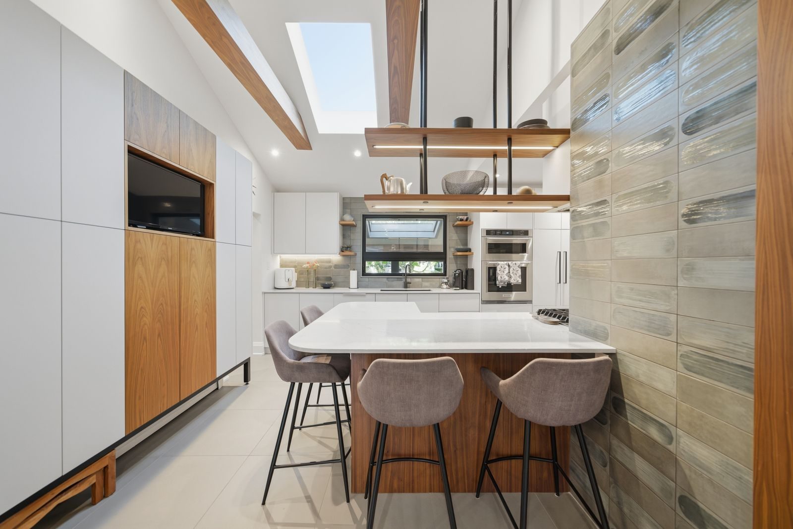 Staged kitchen island and wall unit with a television at 52 Morna Avenue, Guildwood, Scarborough