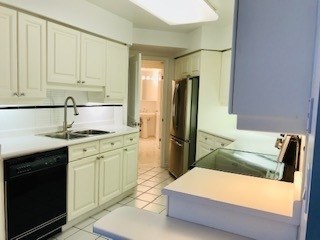 The kitchen at 3911 - 1 Palace Pier Crt — white cabinets and ceramic floor
