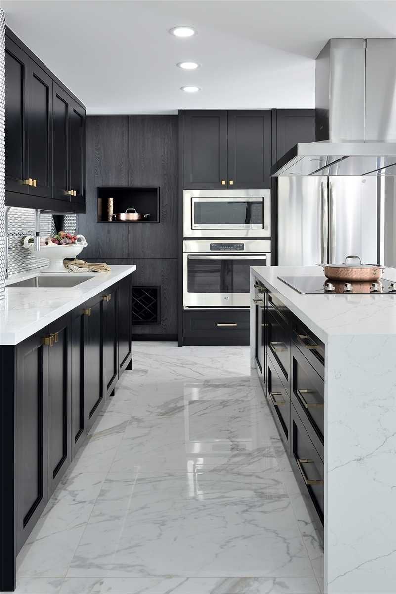 The kitchen at 2201 - 1 Palace Pier Court — black cabinetry, marble floors and stainless wall ovens