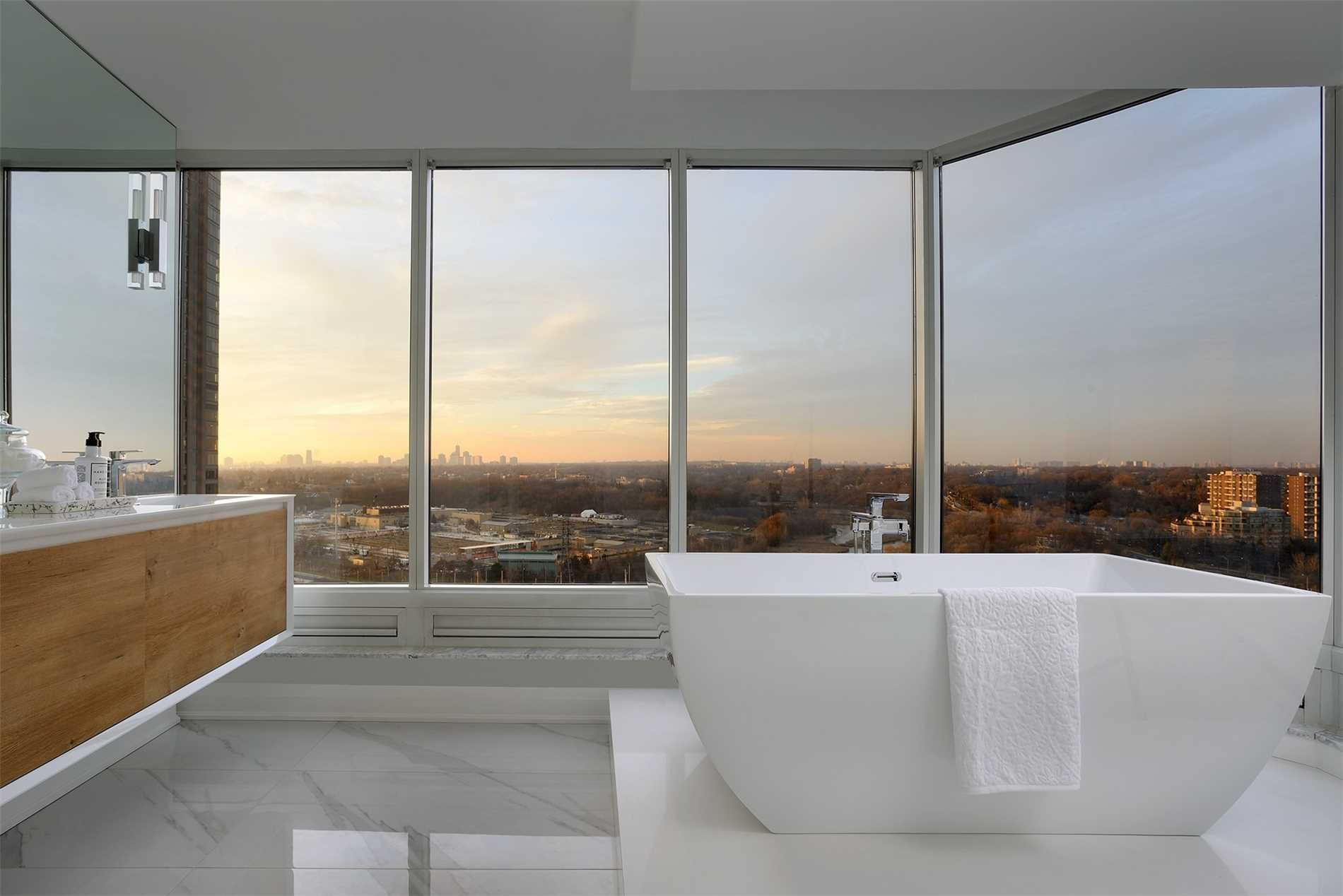 The ensuite at 2201 - 1 Palace Pier Court — freestanding soaker tub before curved windows with city views