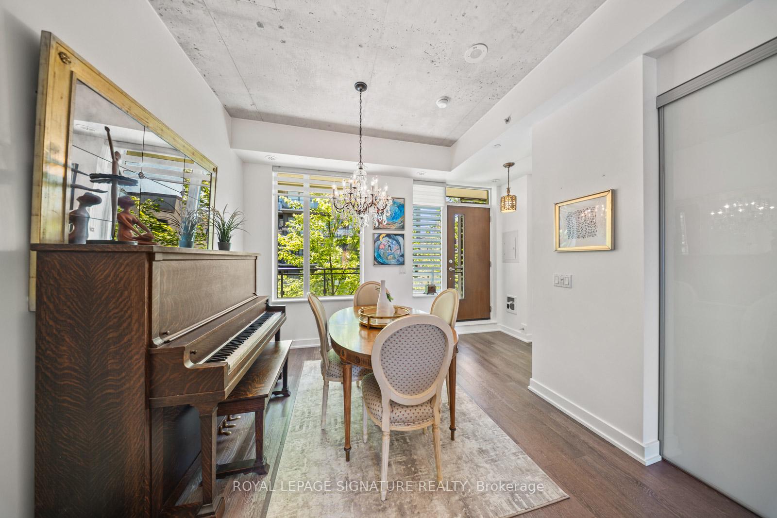 Dining room with exposed concrete ceiling and tree-top views through large windows