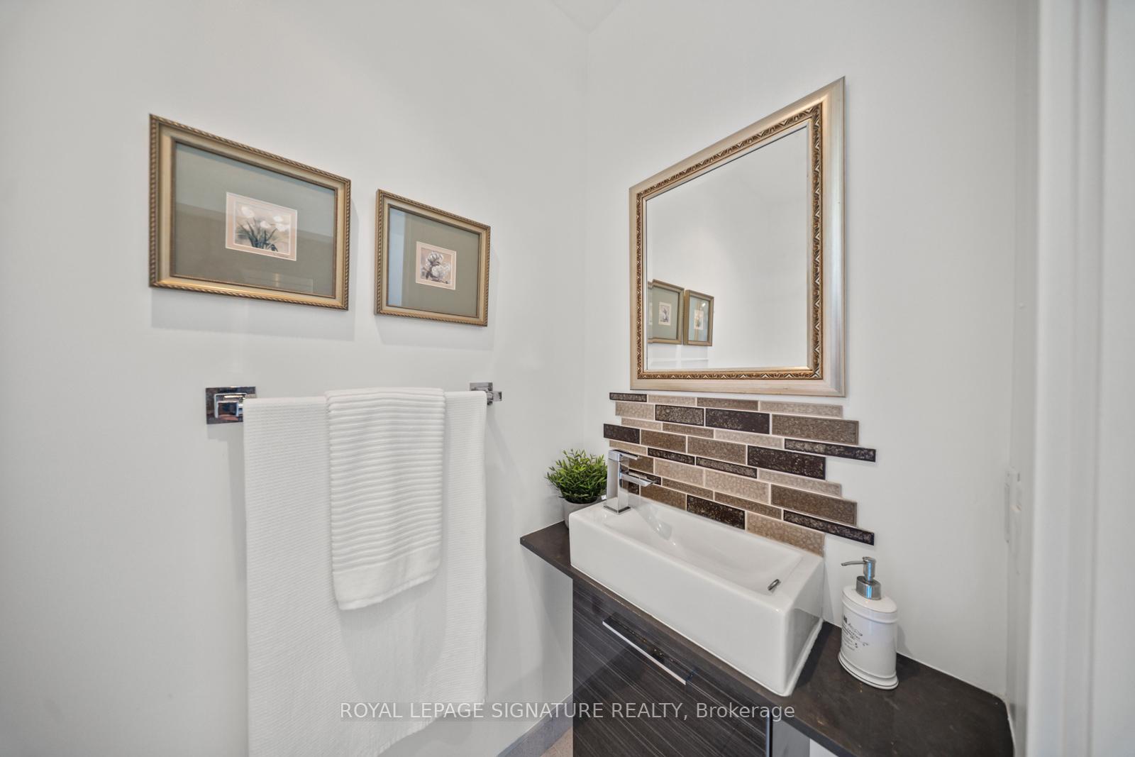 Powder room with vessel-style sink and tiled backsplash