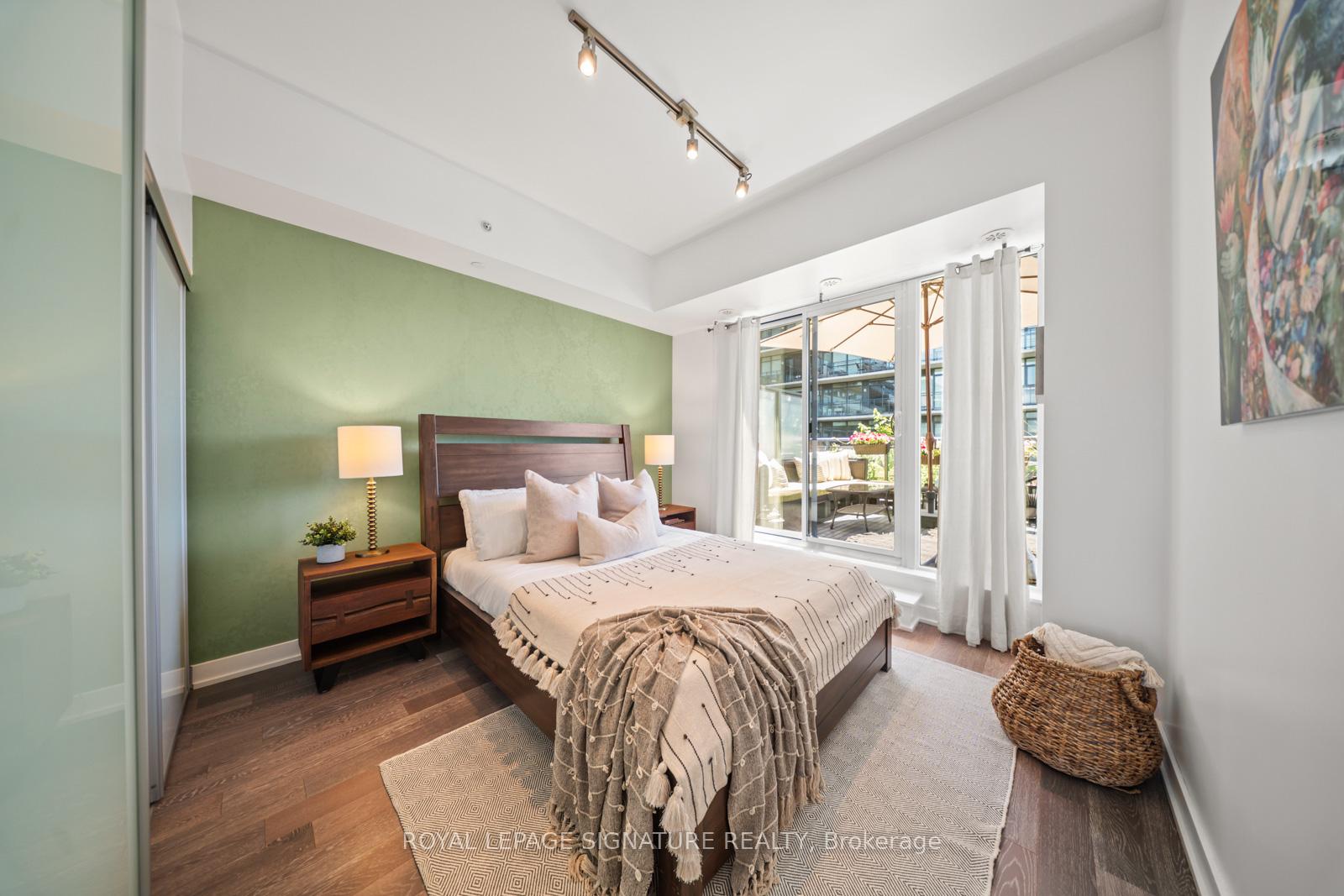 Primary bedroom opening through glass doors to a large private terrace at Suite 331