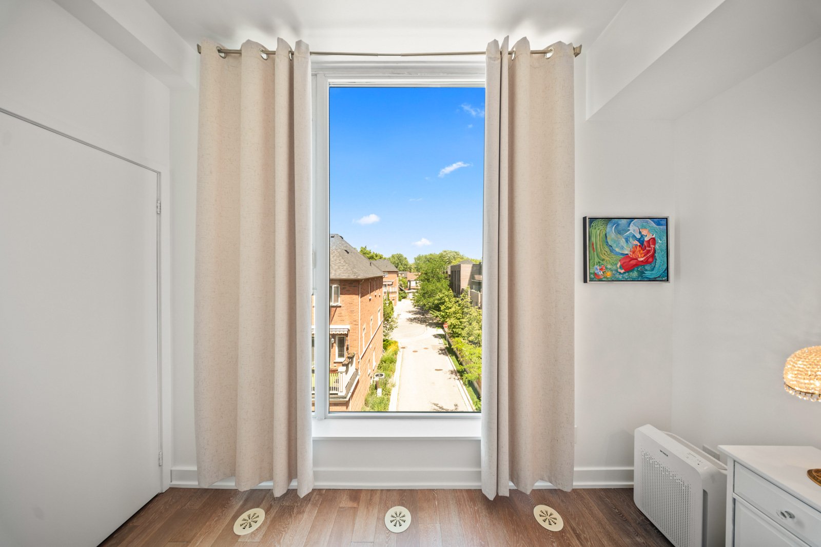 Living room picture window with clear tree-top views from Suite 331 at The Carlaw