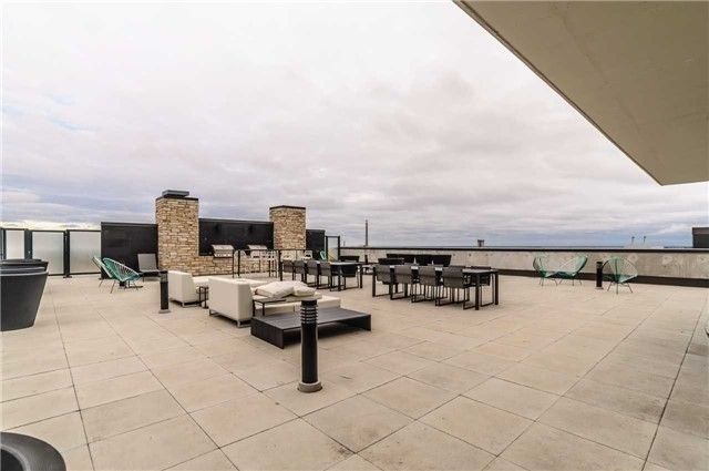 The Carlaw's rooftop terrace with loungers, tables, and BBQs
