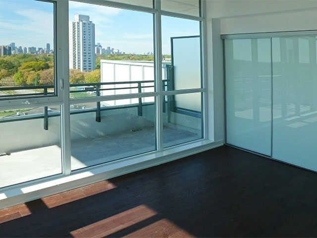 The bedroom at Unit 914 with sliding doors opening to the wrap-around balcony