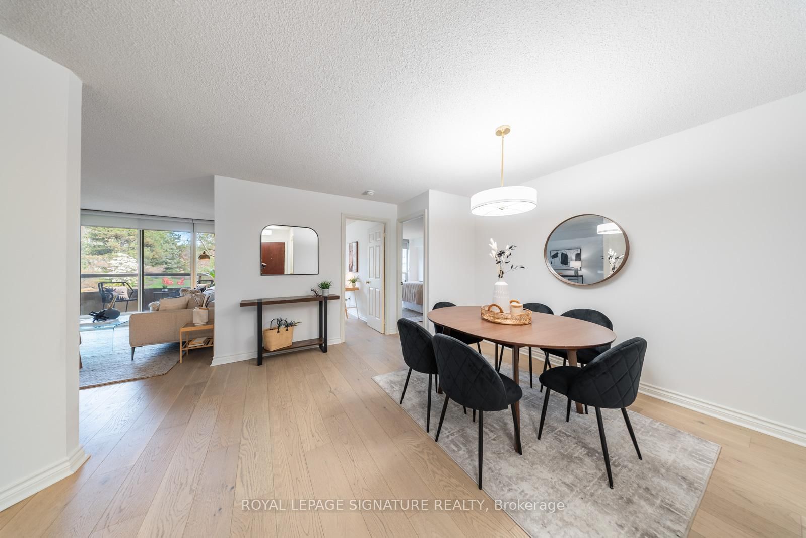 Dining room with hardwood floors opening to the living room