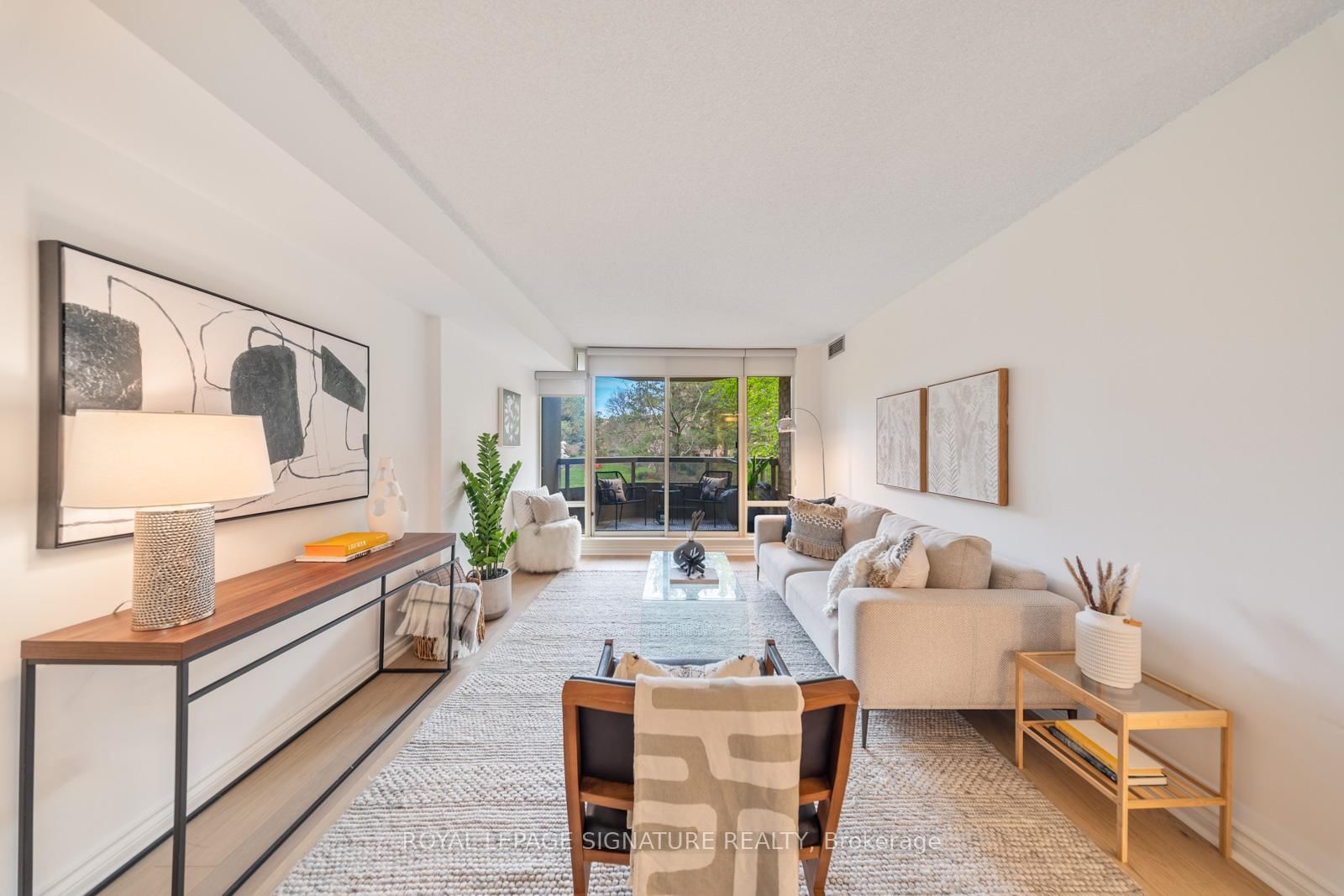 Living room with balcony doors opening to the gardens