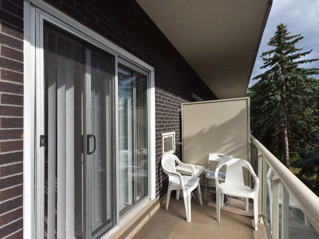 Open balcony with seating, looking along the brick building exterior