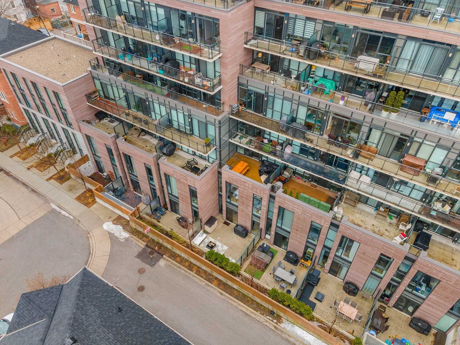 Aerial view of The Taylor Lofts with townhouse units and private patios at the base