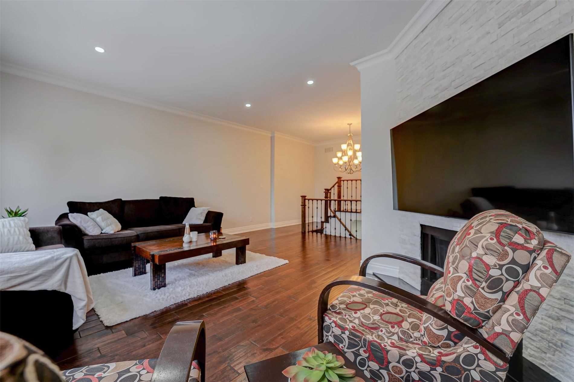 Family room with fireplace and wall-mounted TV at 1447 Evenside Crescent