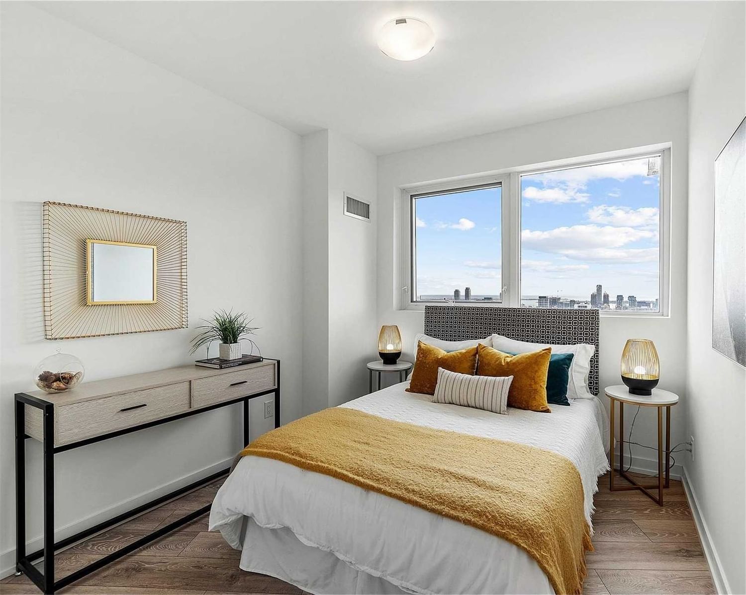Second staged bedroom at Suite 2308 with skyline views through the windows