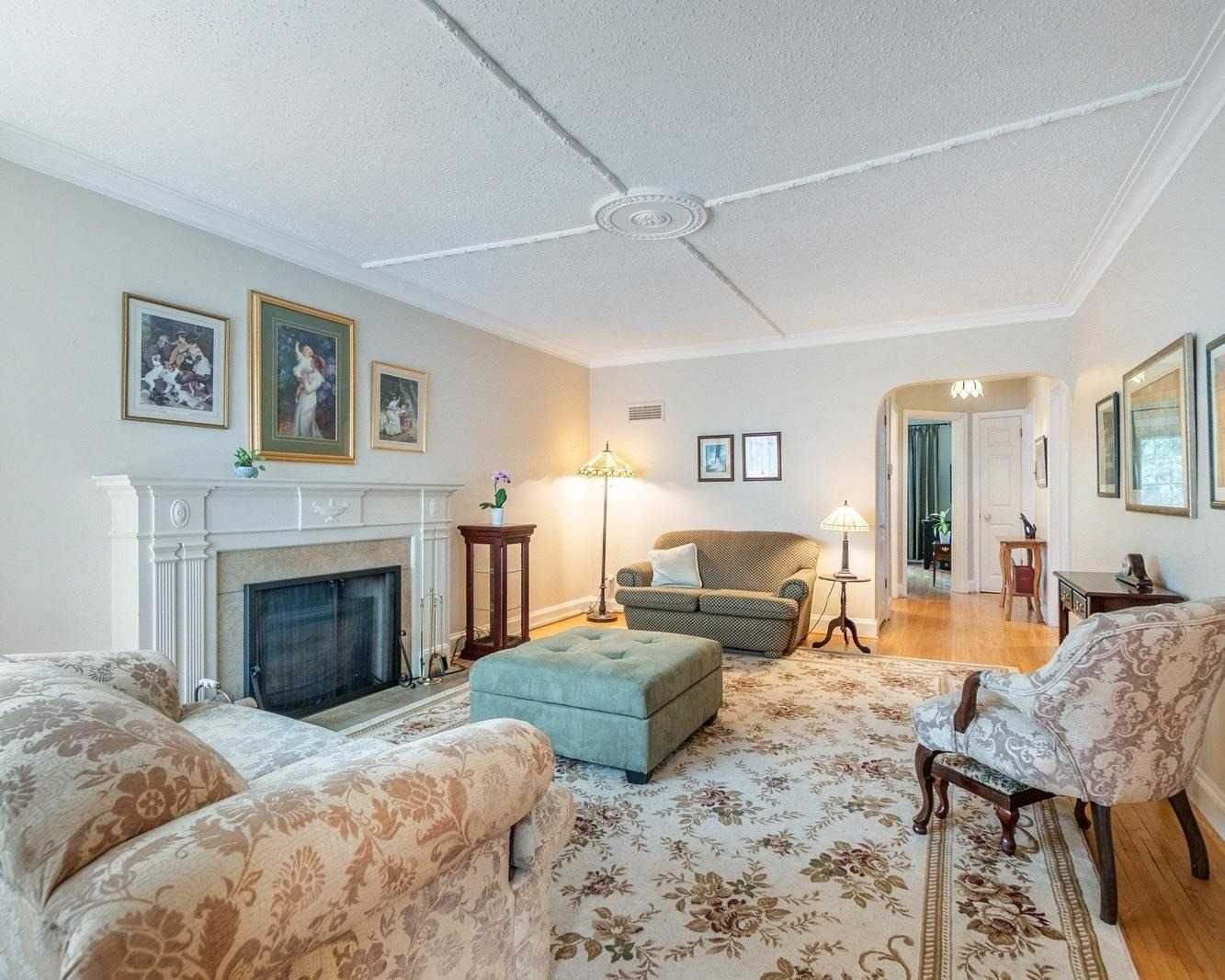 Living room with fireplace and classic millwork at 165 The Kingsway