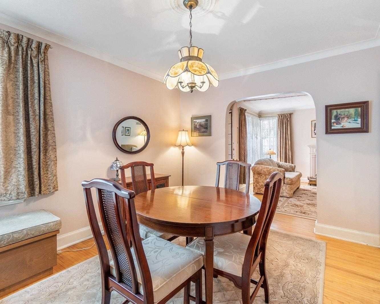 Dining room with round wooden table and arched opening