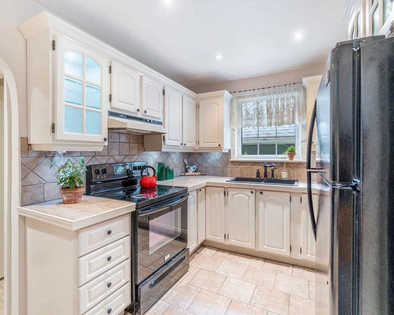 Kitchen with white cabinetry at 165 The Kingsway