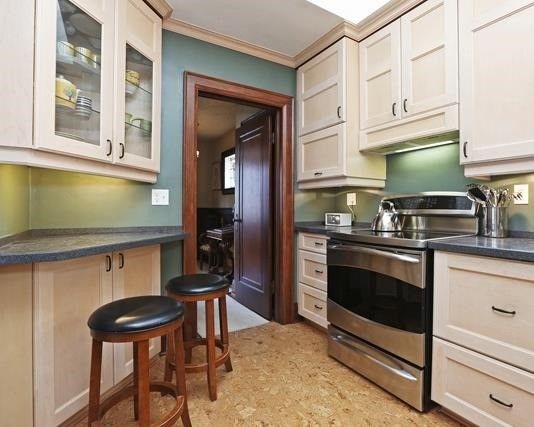 Kitchen with warm cork flooring at 17 Courcelette Road, Toronto