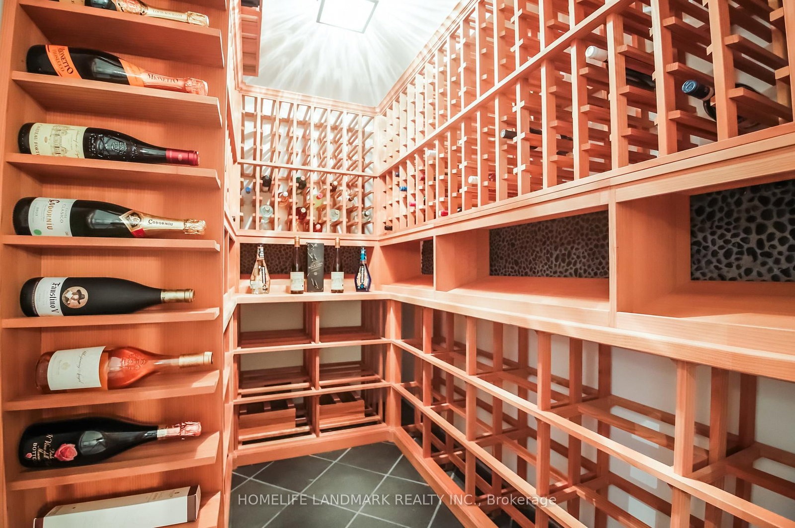 The wine cellar at 1733 Kingston Road — floor-to-ceiling wood racking with a glass wall