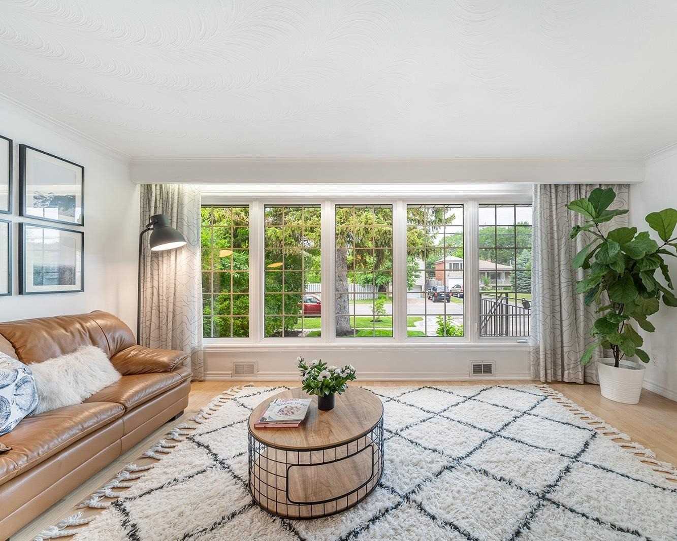 Full-width living room windows overlooking the street
