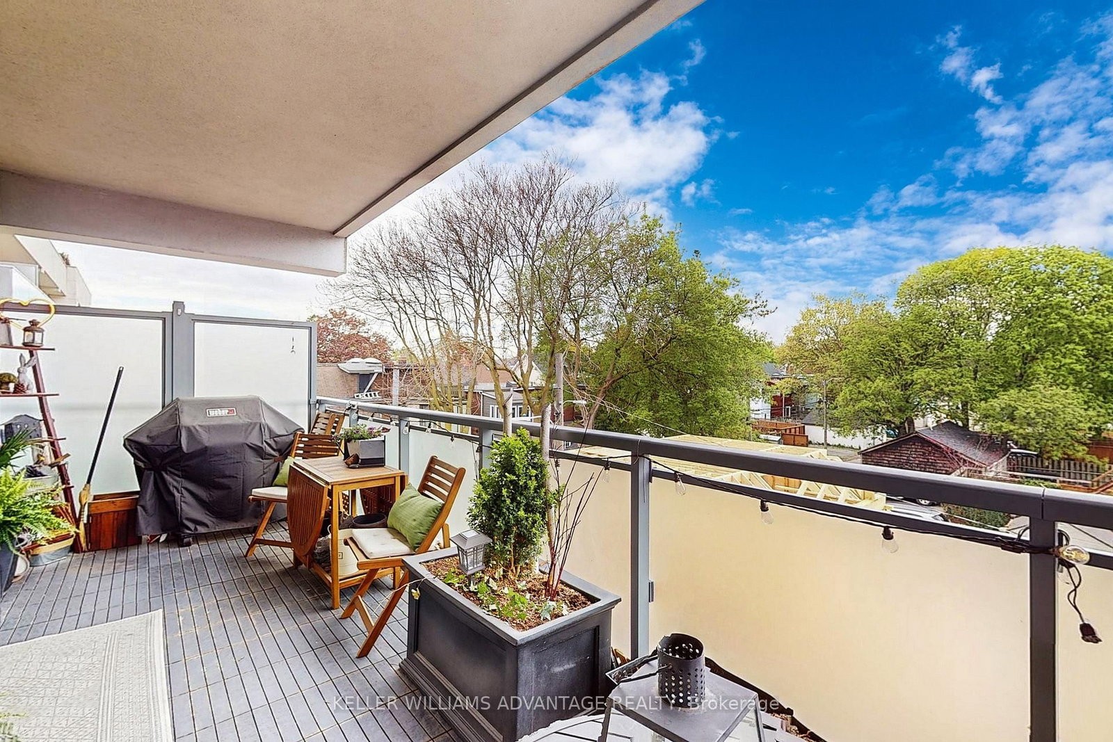 The terrace at 308 - 200 Woodbine Avenue — covered outdoor living space with dining set, barbecue and planters