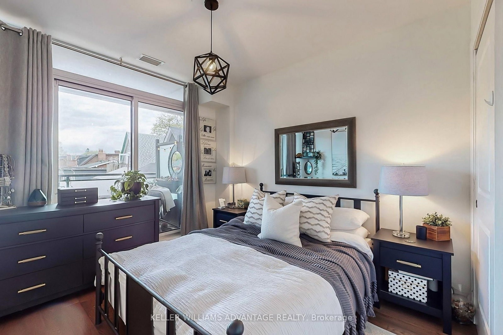 The primary bedroom at 308 - 200 Woodbine Avenue — bright with a walkout to the terrace