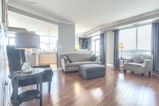 The living room at 1709 - 2111 Lake Shore Blvd W — tall windows and hardwood floors