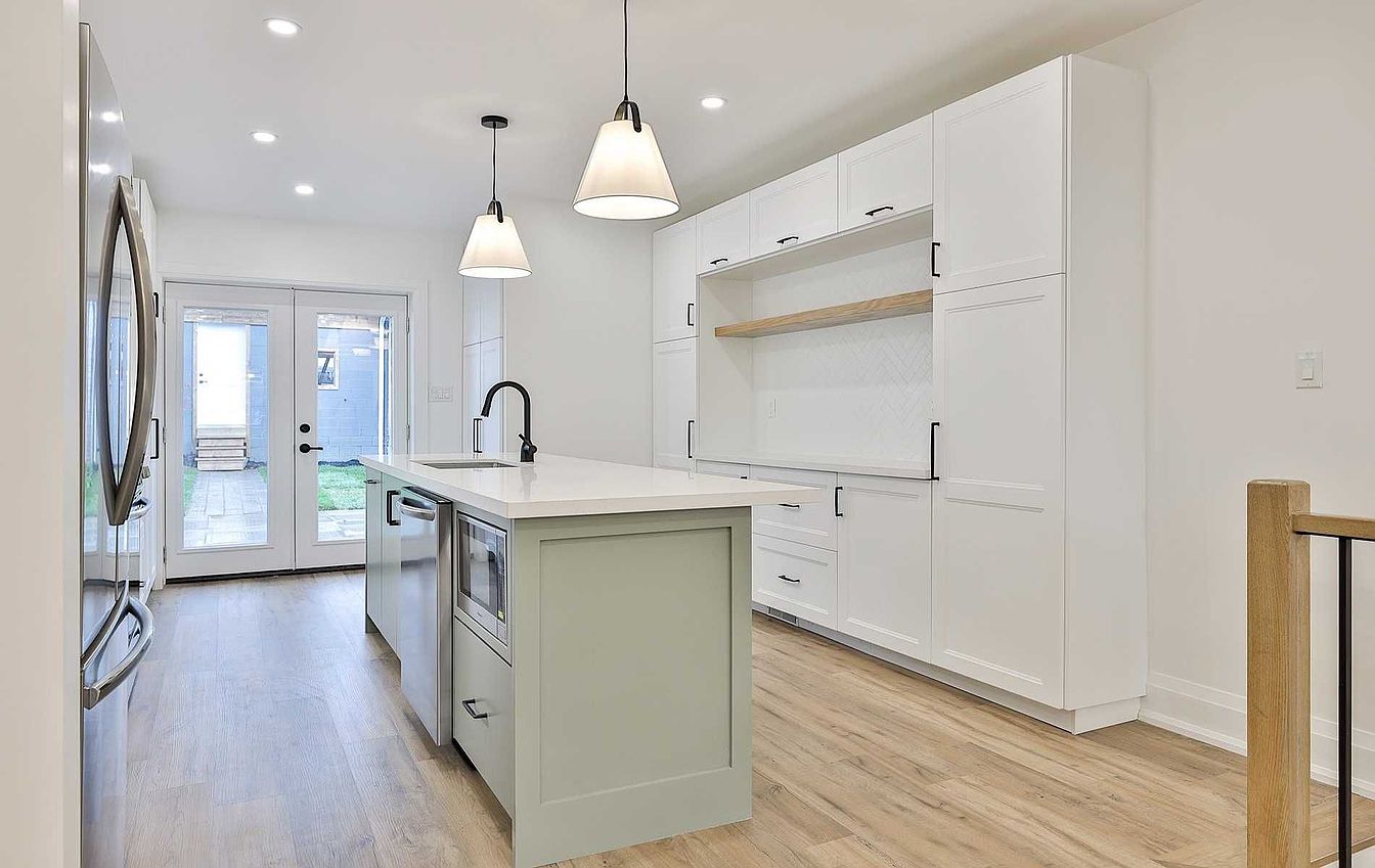 Kitchen island with French doors opening to the backyard