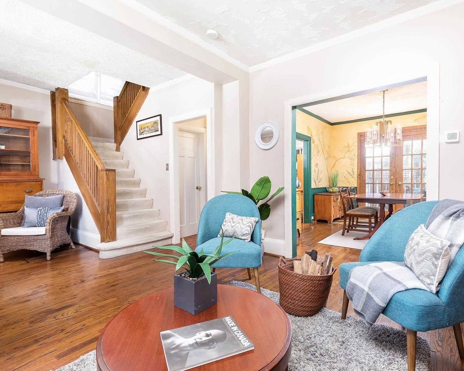 Wooden staircase and hall at 37 Wheatfield Road, with the dining room beyond