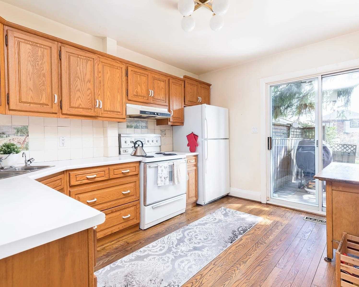 Kitchen of 37 Wheatfield Road with wood cabinets and a sliding door to the deck