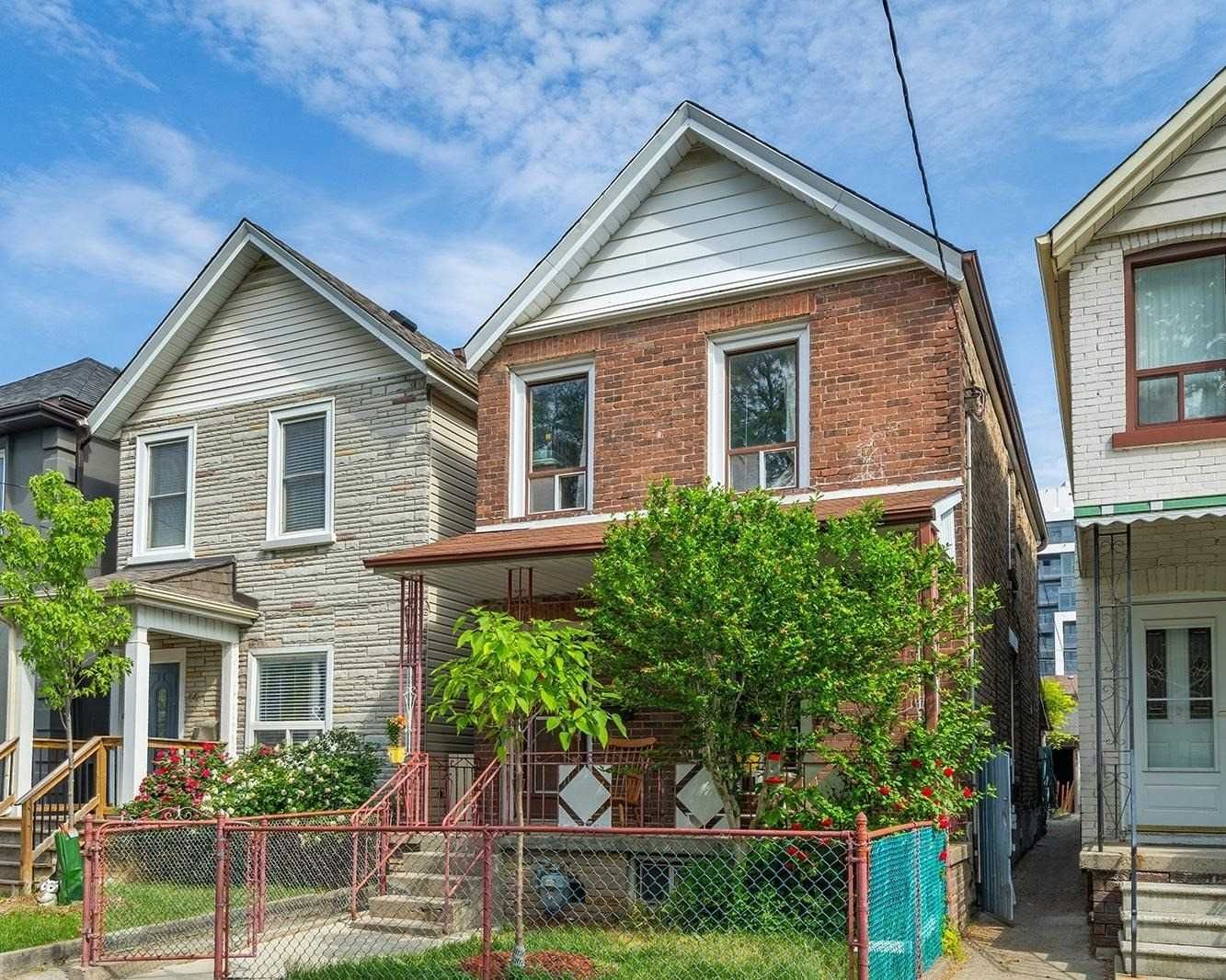 Front exterior of 42 Melville Avenue among its Dupont/Christie neighbours