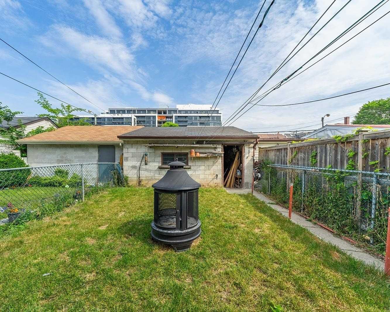 Backyard with chiminea, detached garage, and fenced yard