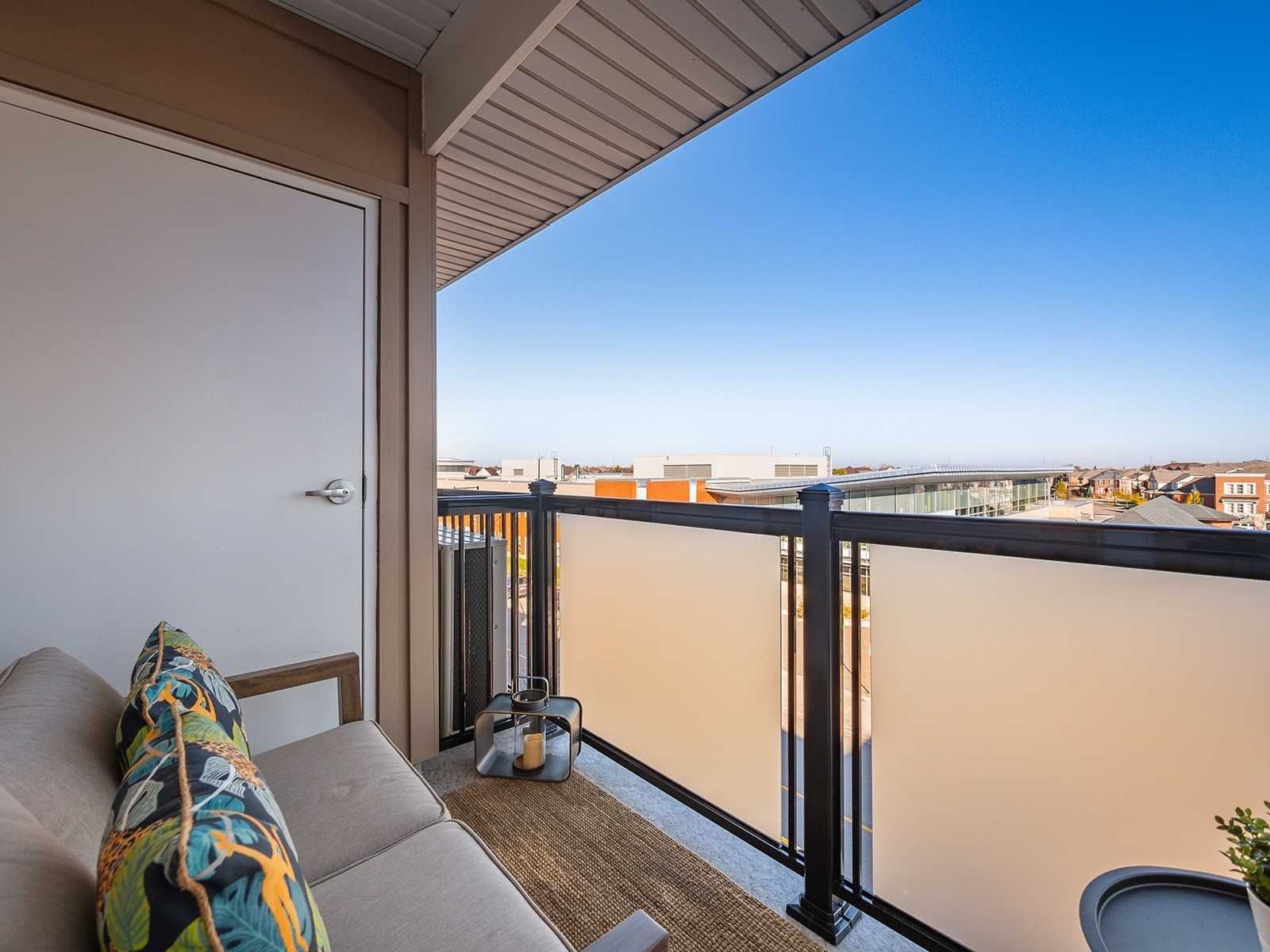 Private balcony with frosted glass railing overlooking Mount Pleasant, Brampton