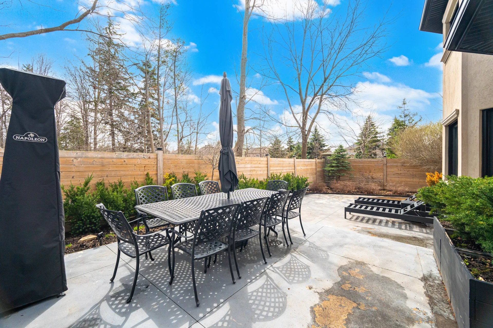 Covered patio and fenced backyard at 61 Woodland Trail Court, Vaughan — steps from Boyd Conservation Park