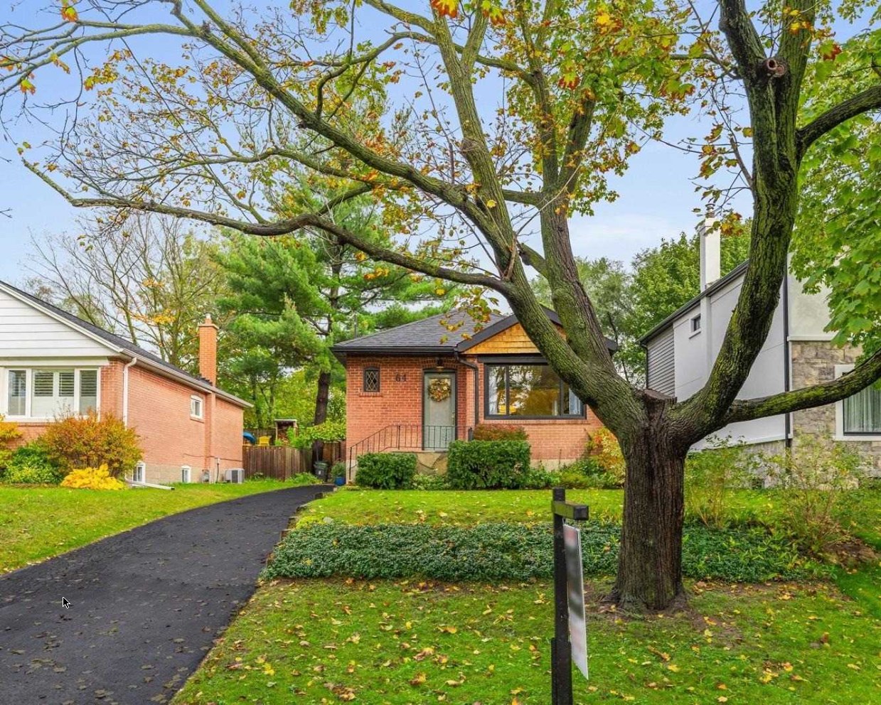 Front exterior of 64 Delroy Drive, an impeccably maintained brick bungalow in autumn