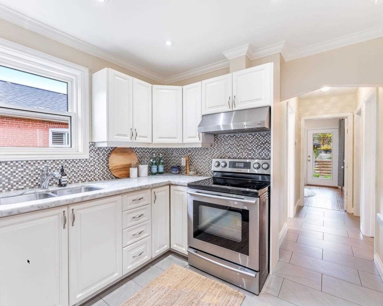 Kitchen with mosaic backsplash at 64 Delroy Drive