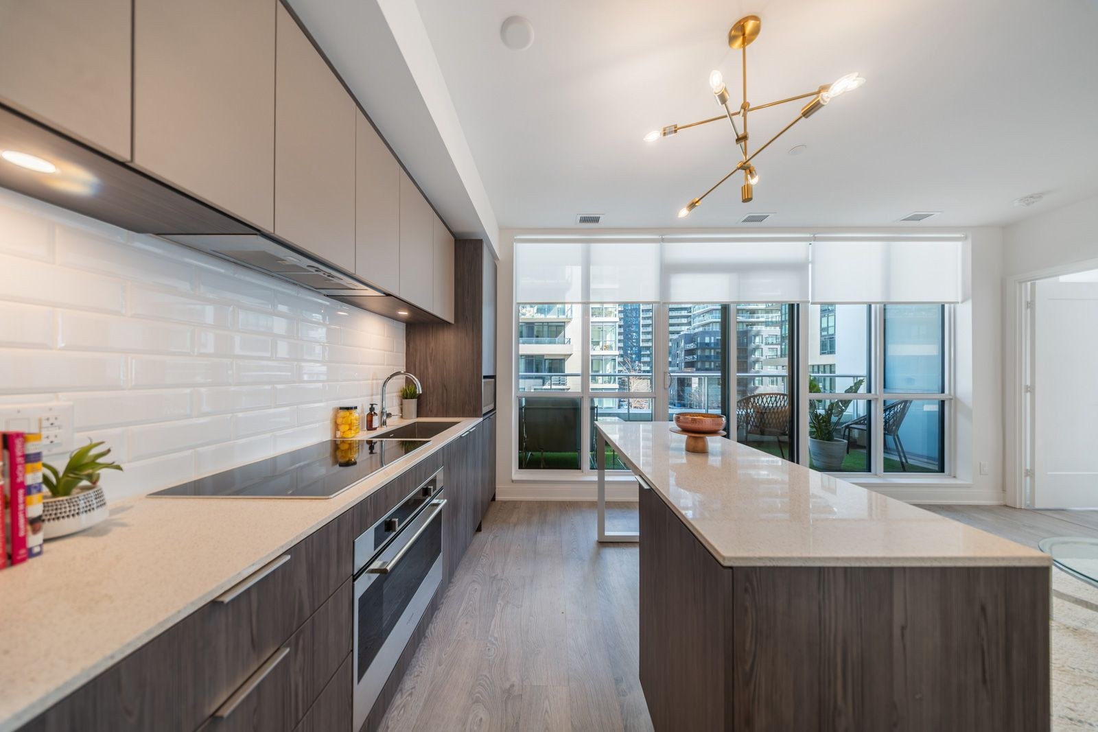 Kitchen with subway tile backsplash, island and terrace walkout